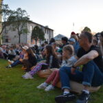 Publiczność siedząca na trawie