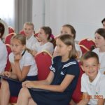 Dzieci siedzace na krzesłach