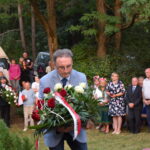 kwiaty biało czerwone grób zielona trwawa ludzie