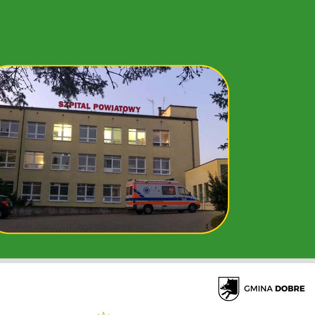 Zdjęcie przedstawia żółty budynek szpitala z napisem Szpital Powiatowy. Na parkingu stoi karetka pogotowia. W tle niebo o zmierzchu, otoczone zielenią.