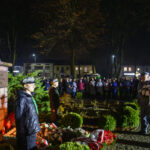 DSC_5581 Pomnik Józefa Piłsudskiego otoczony wieńcami. W tle noc i tłum ludzi. Harcerze i żołnierze stoją obok pomnika.